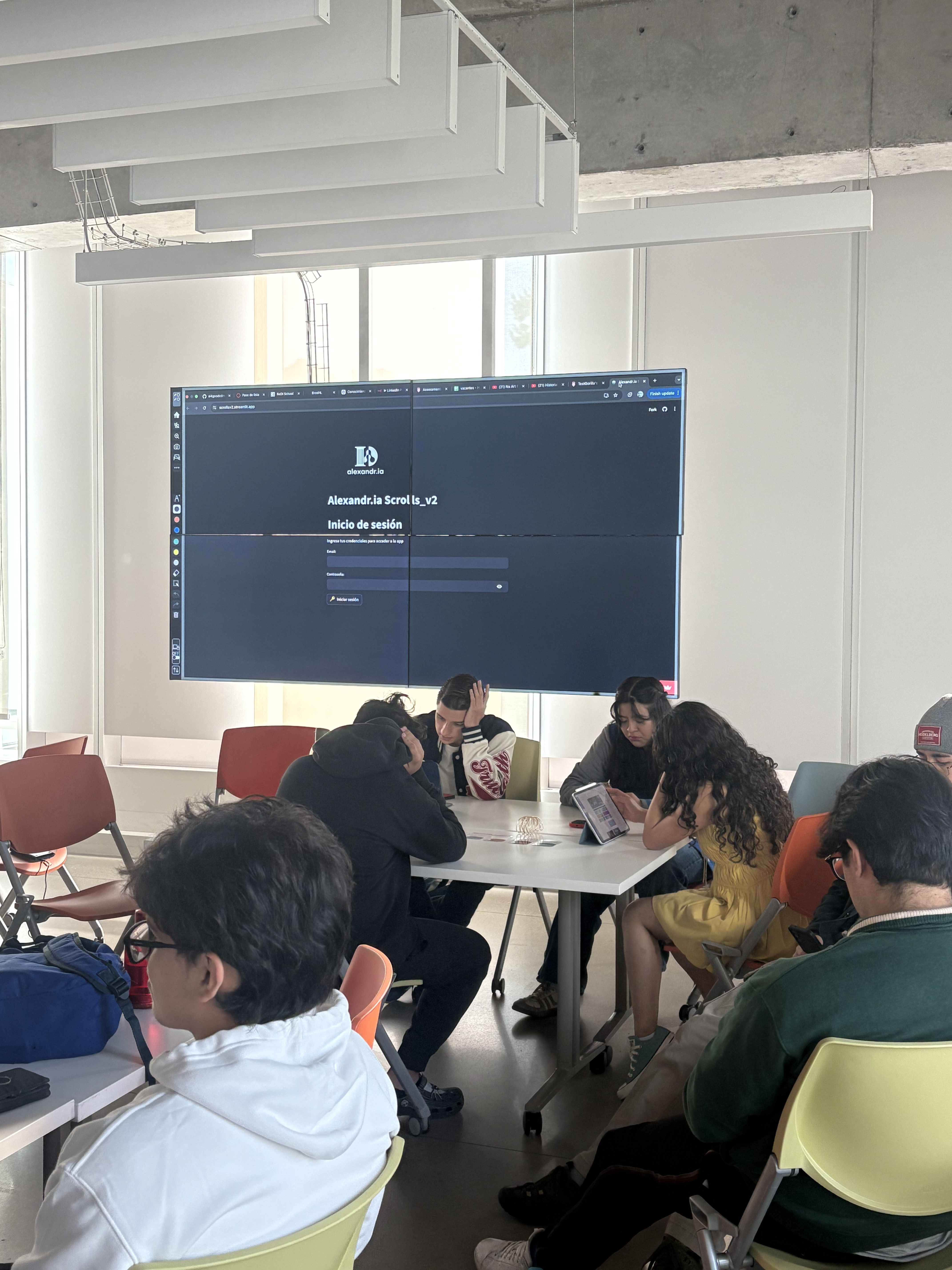 Students in a classroom using Alexandr.ia Scroll_v2 displayed on a large screen