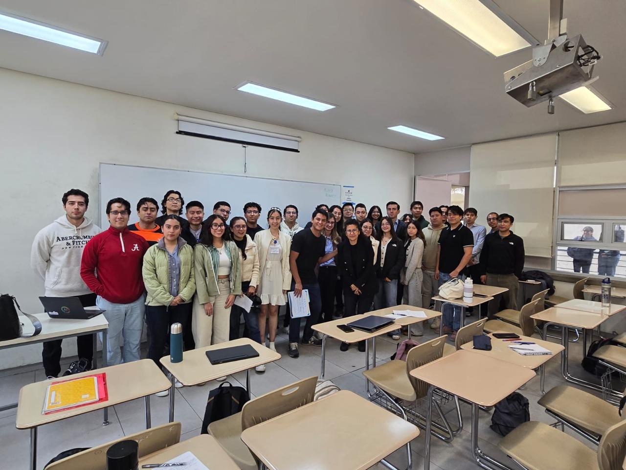 Group of students and Alexandr.ia team members posing together in a classroom